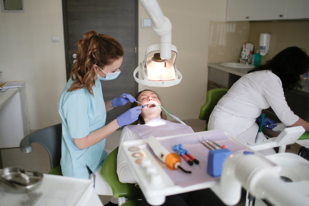 A dentist conducts a dental checkup on a patient in a modern clinic, focusing on oral hygiene.